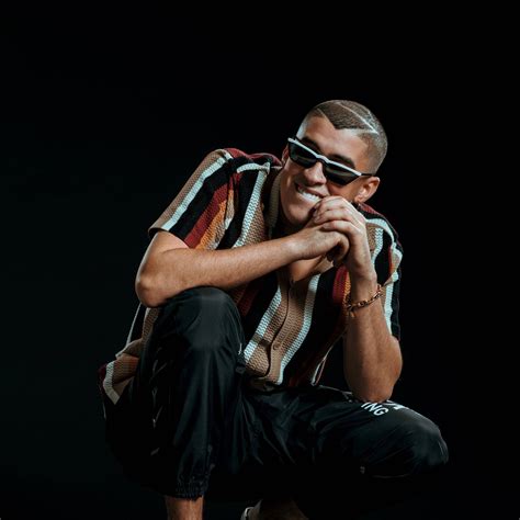 Bad Bunny wearing Prada SPR19U Sunglasses .